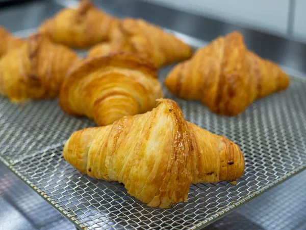Butter croissants on a cooling rack (sample photo)